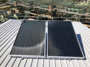 Solar hot water panels fitted to a metal roof in Maroochydore, forming part of an energy-efficient hot water system