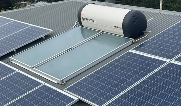 Solar hot water system mounted on a metal roof alongside PV panels in Maroochydore